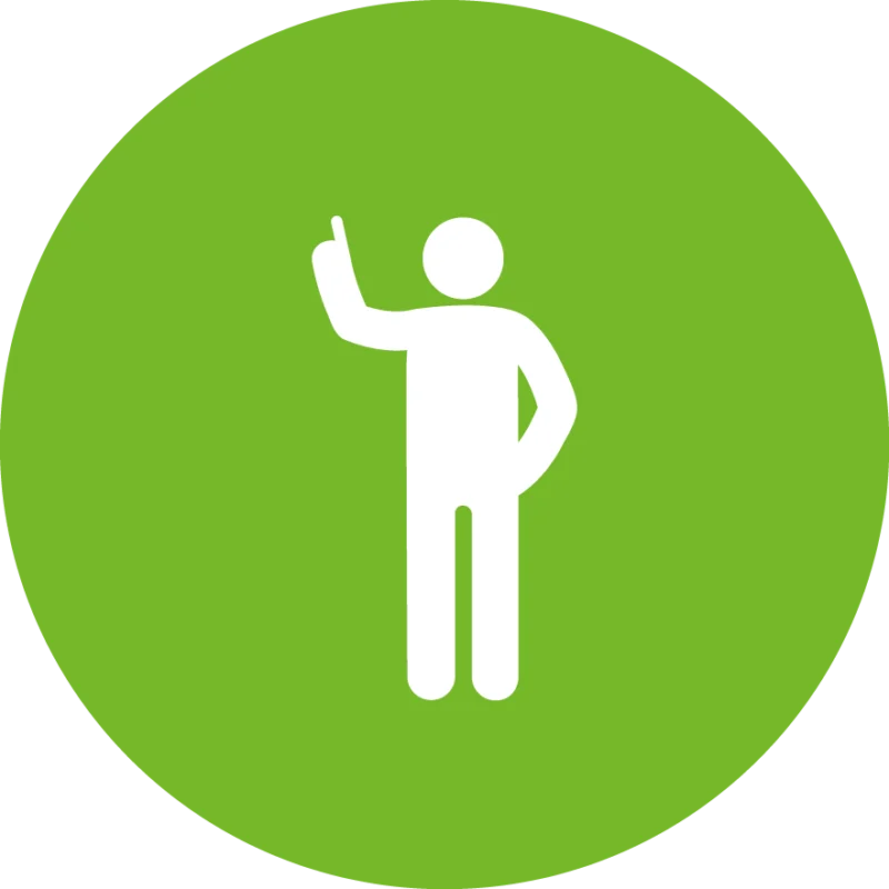Weißes Piktogramm einer stehenden Person auf grünem Kreis, die einen Arm hebt und mit dem Zeigefinger nach oben zeigt – symbolisiert Hinweis, Information oder Aufmerksamkeit.