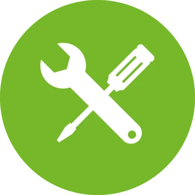 Weißes Piktogramm aus gekreuztem Schraubenschlüssel und Schraubendreher auf grünem, kreisförmigem Hintergrund. Das Symbol steht für Handwerk, Reparatur, Wartung oder technischen Service.